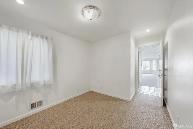 a view of an empty room and a window