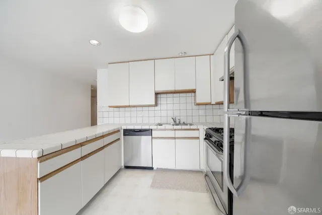 a kitchen with a sink stove and cabinets