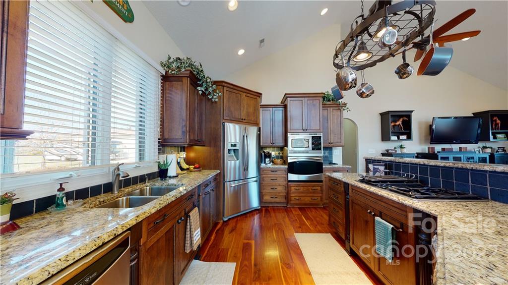 3908 Thompson Road Lancaster, SC 29720 - Photo 17 of 36 a kitchen with stainless steel appliances granite countertop a stove and a sink