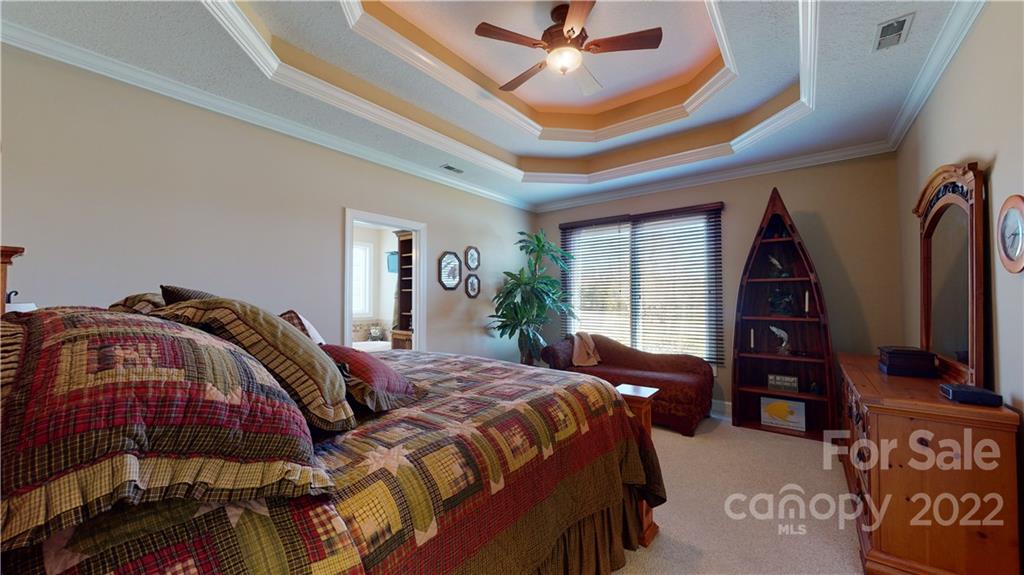 3908 Thompson Road Lancaster, SC 29720 - Photo 23 of 36 a bedroom with a bed a dresser and a chandelier