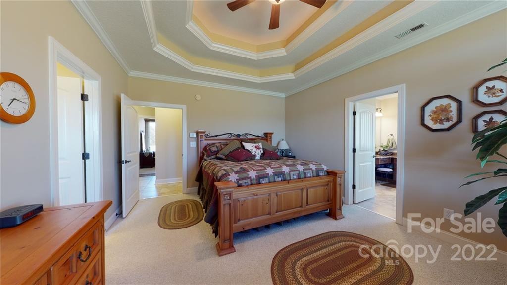 3908 Thompson Road Lancaster, SC 29720 - Photo 24 of 36 a bedroom with a bed and a chandelier