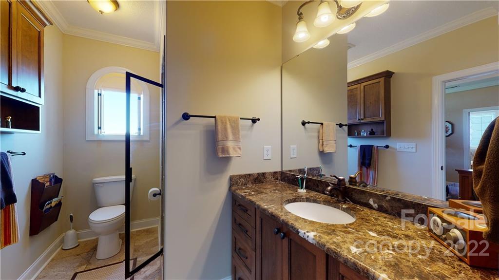 3908 Thompson Road Lancaster, SC 29720 - Photo 25 of 36 a bathroom with a granite countertop sink a toilet a mirror and shower