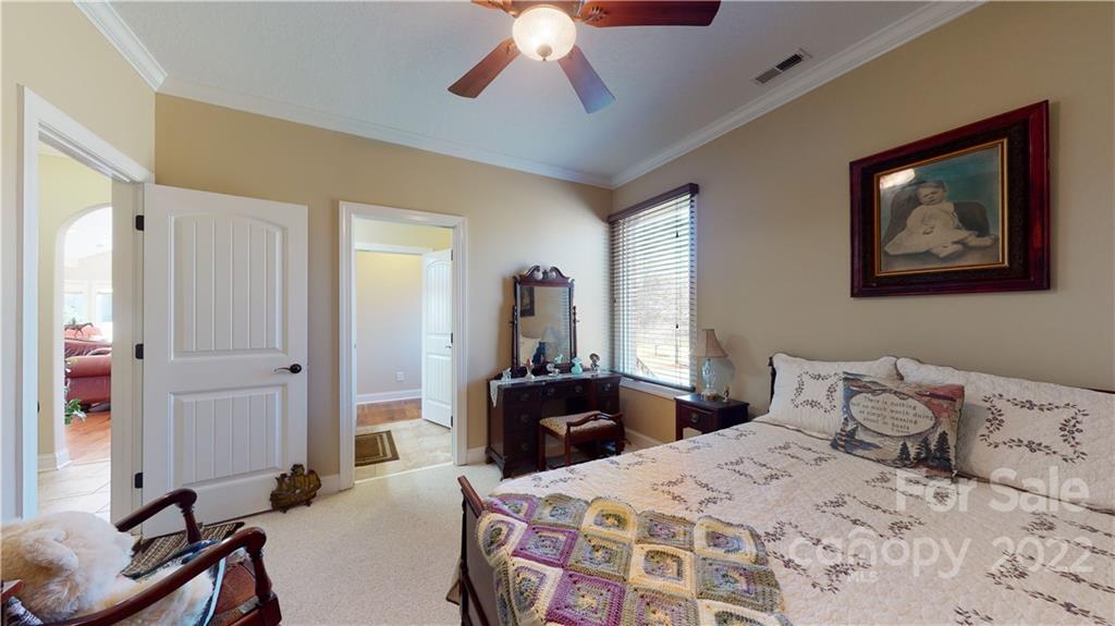 3908 Thompson Road Lancaster, SC 29720 - Photo 29 of 36 a bedroom with a bed and a chandelier