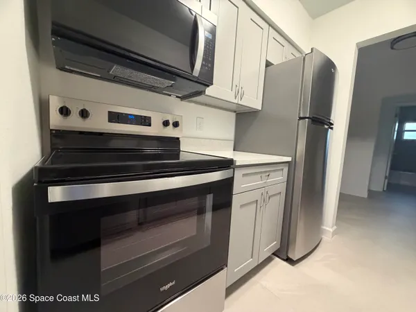 a kitchen with stainless steel appliances a stove and a refrigerator