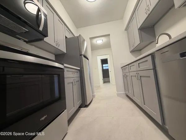 a kitchen with stainless steel appliances granite countertop a refrigerator and a stove