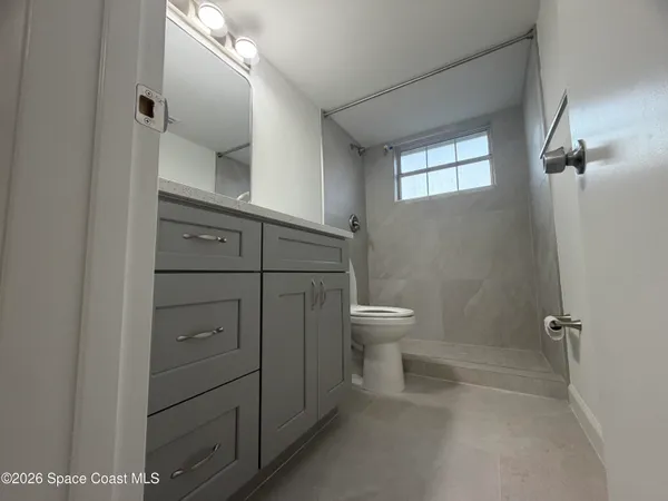 a bathroom with a toilet sink and shower