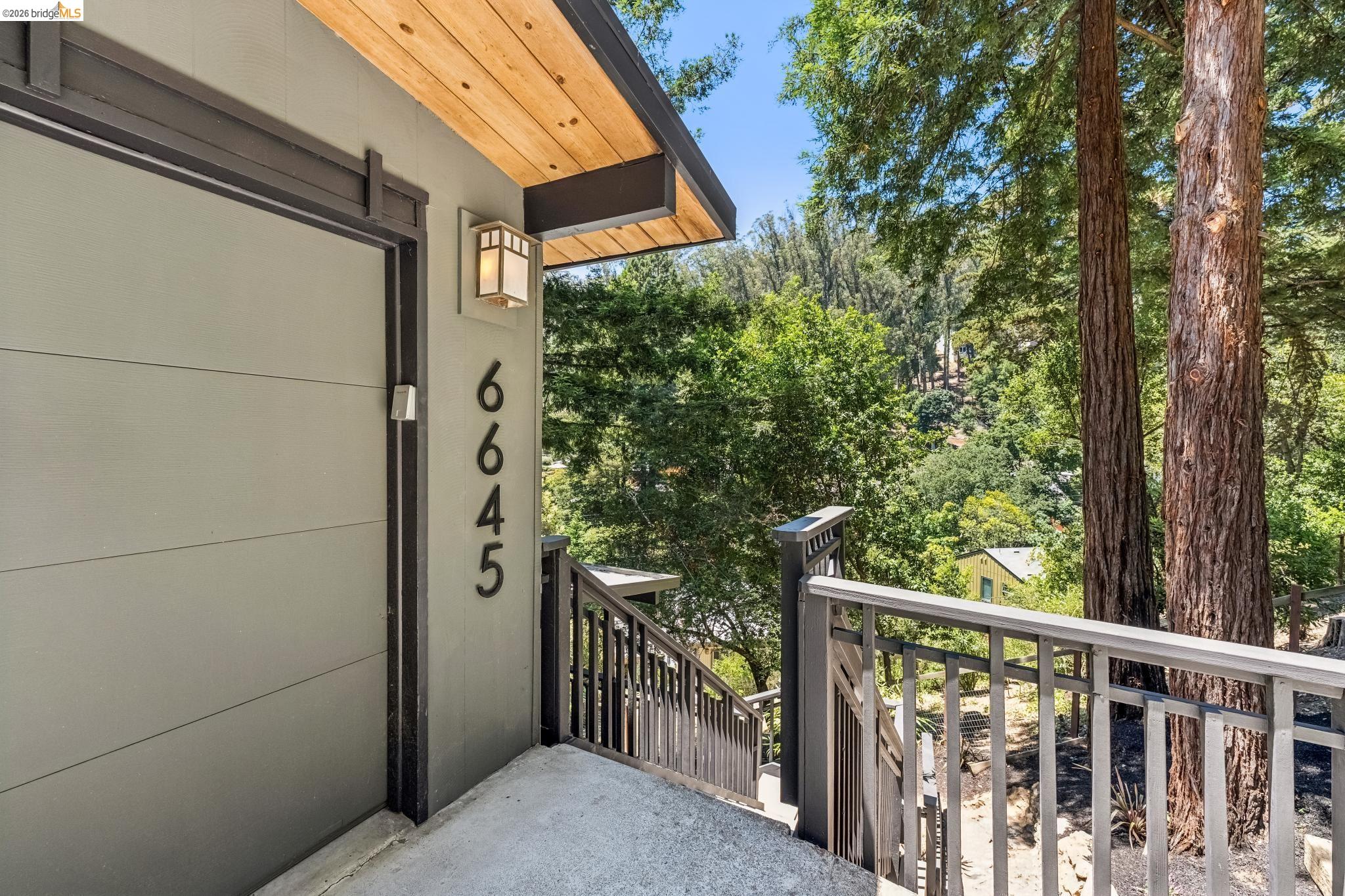 6645 Heather Ridge Way Oakland, CA 94611 - Photo 7 of 61 Modern exterior featuring horizontal siding and a wood-paneled ceiling