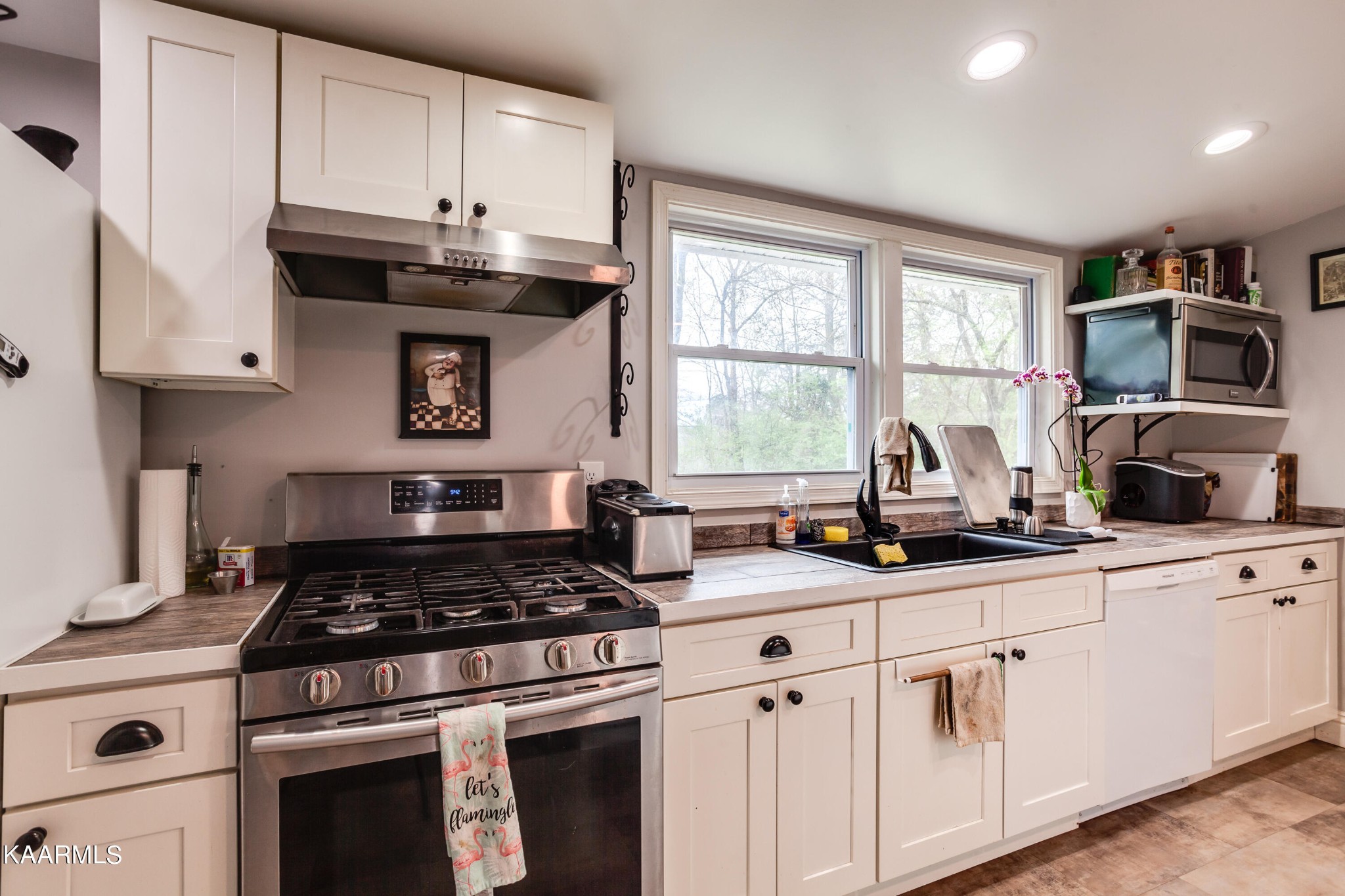 303 West Faunce Road Oak Ridge, TN 37830 - Photo 11 of 28 a kitchen with cabinets appliances a sink and a window