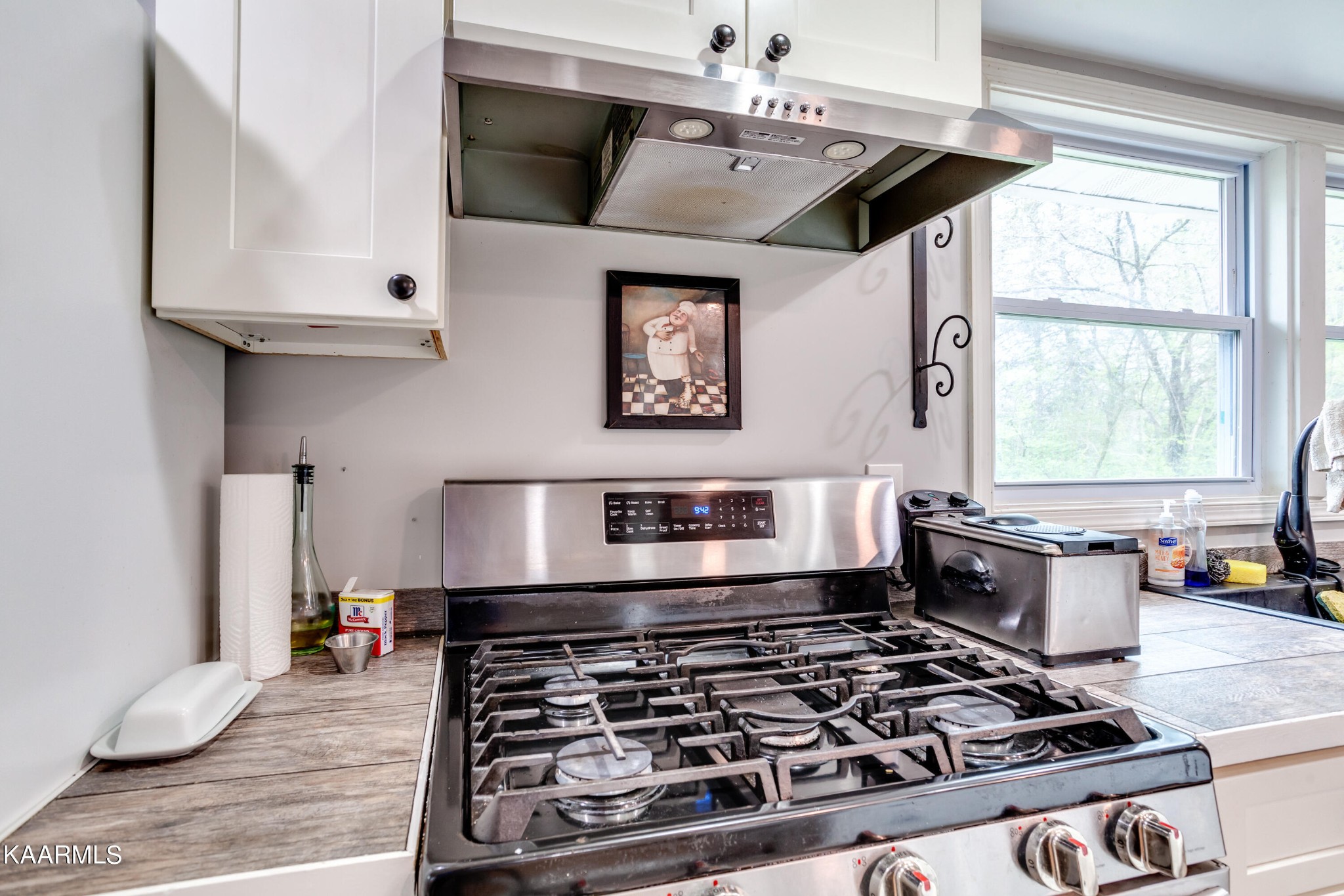 303 West Faunce Road Oak Ridge, TN 37830 - Photo 12 of 28 a kitchen with stainless steel appliances granite countertop a stove and a microwave