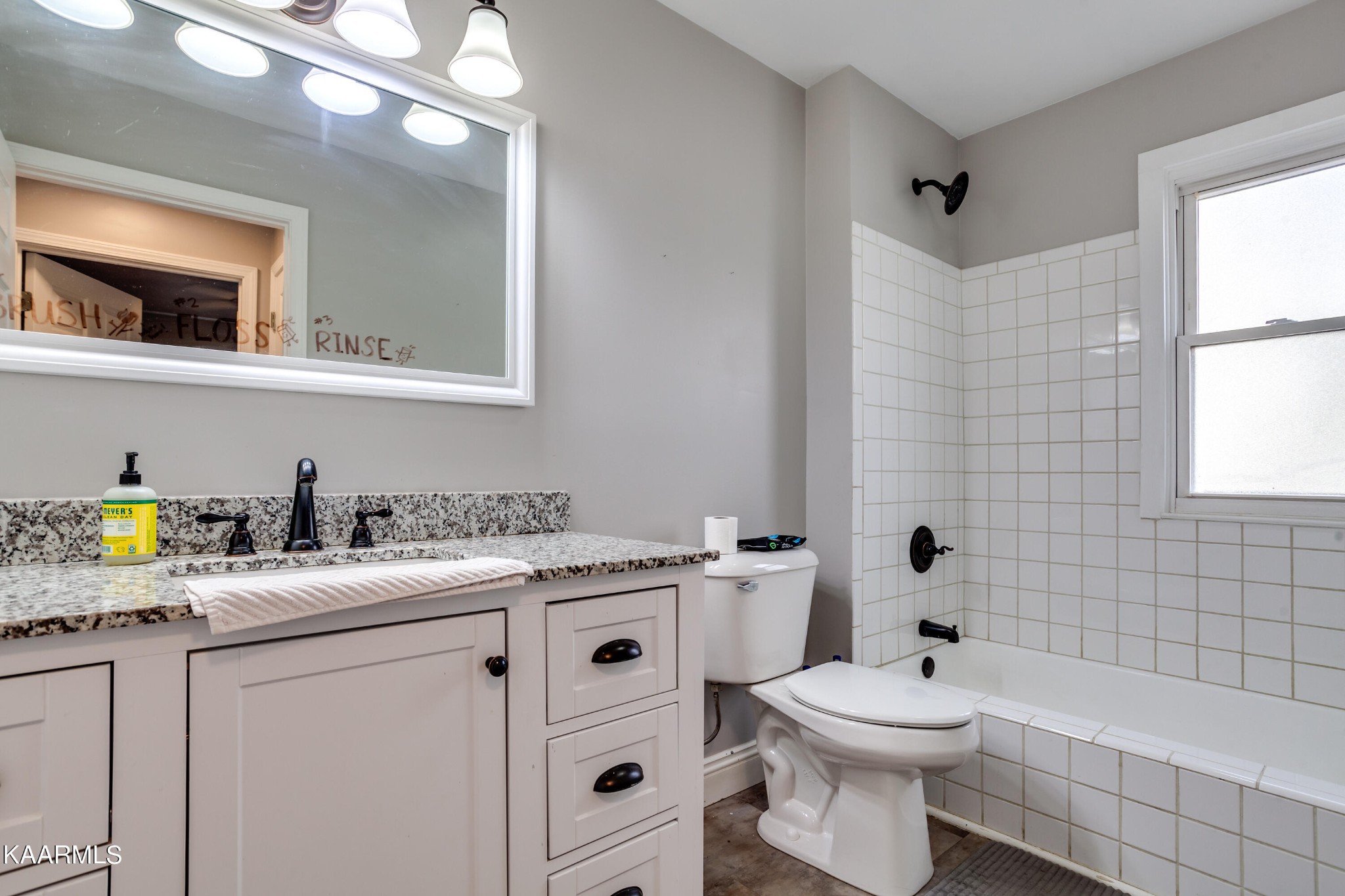 303 West Faunce Road Oak Ridge, TN 37830 - Photo 23 of 28 a bathroom with a granite countertop toilet sink and mirror