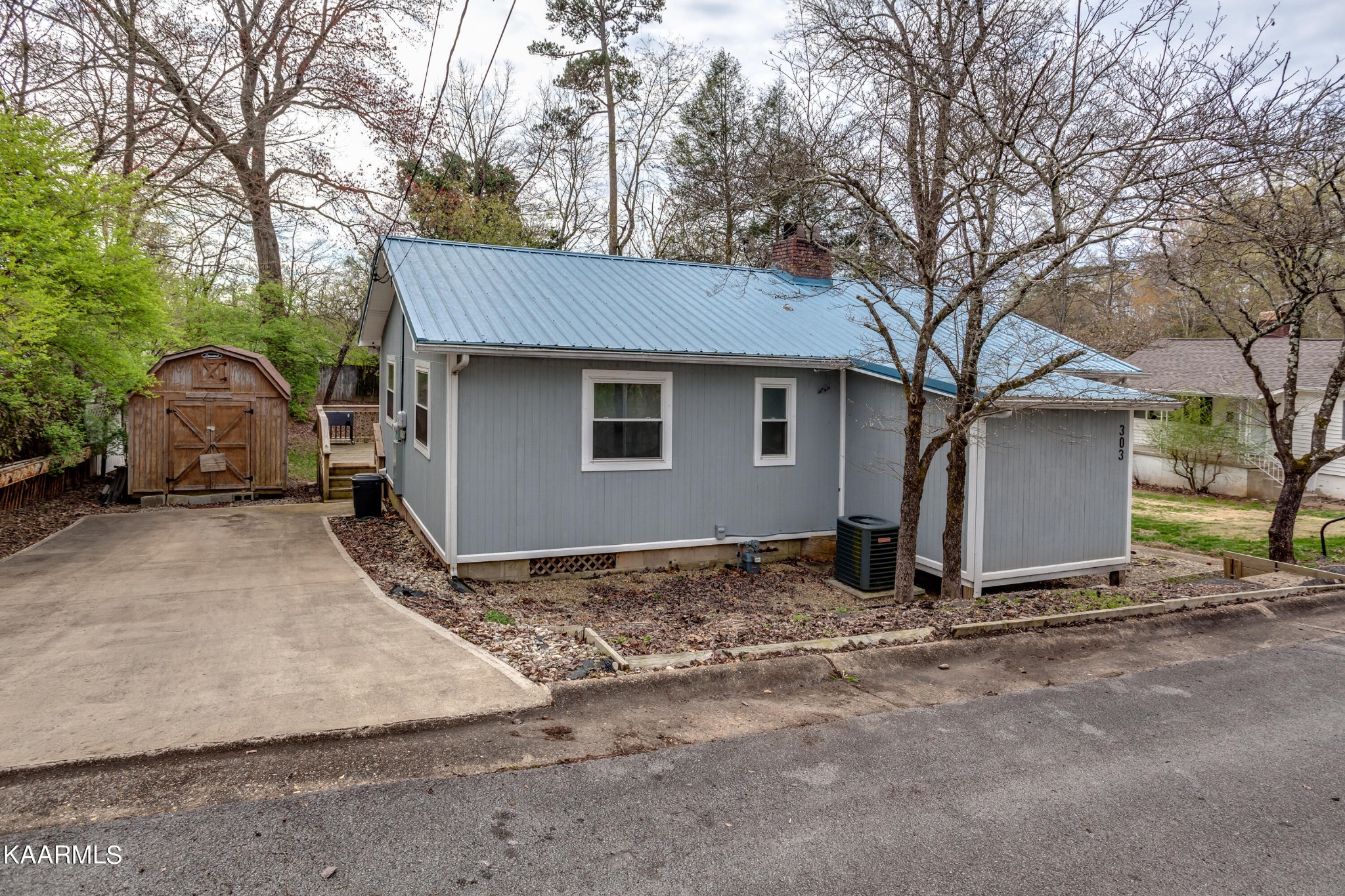 303 West Faunce Road Oak Ridge, TN 37830 - Photo 3 of 28 a view of a house with a yard and garage