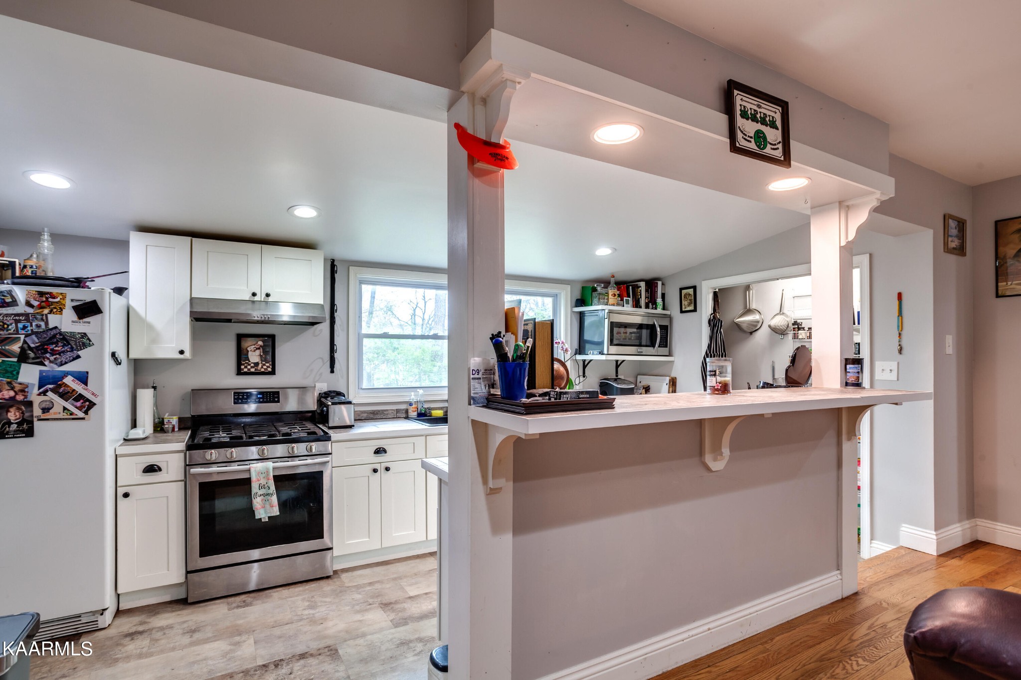 303 West Faunce Road Oak Ridge, TN 37830 - Photo 10 of 28 a kitchen with stainless steel appliances a stove sink and cabinets