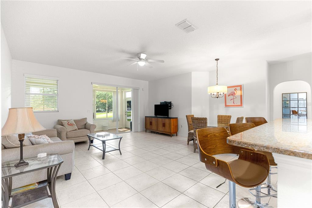 9317 Southwest 94th Loop Ocala, FL 34481 - Photo 6 of 40 a living room with furniture and a table