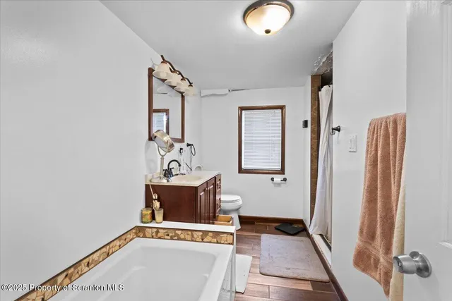 a view of an entryway with wooden floor