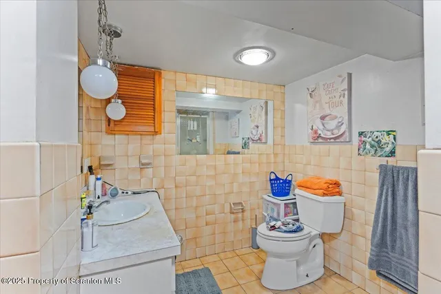 a bathroom with a sink toilet and mirror