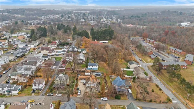 an aerial view of a house with a swimming pool outdoor seating and yard