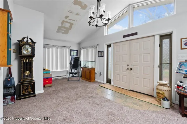 a view of an empty room with workspace and a ceiling fan