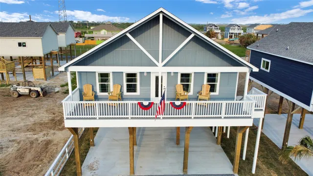 an aerial view of a house with a yard from a balcony