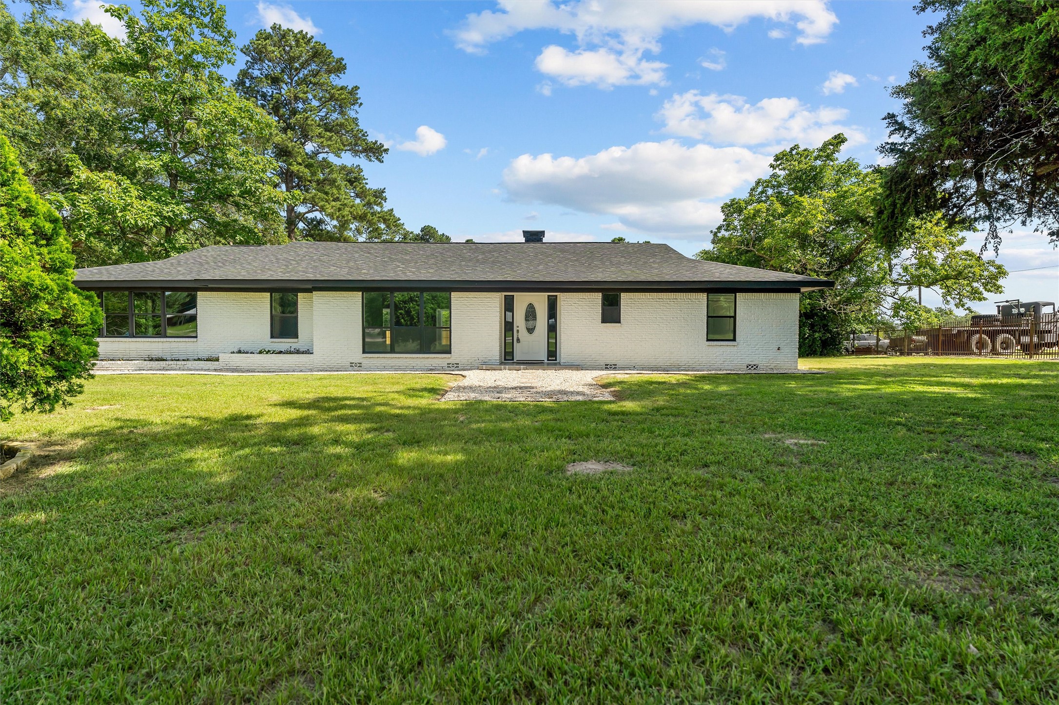 a front view of house with yard and green space
