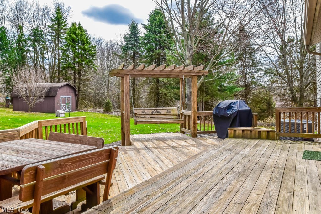 6955 Taylor Road Clinton, OH 44216 - Photo 21 of 26 Multi-tiered deck featuring a pergola with a swing.