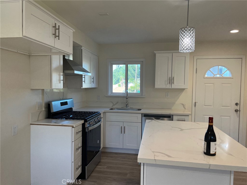 2228 Ridgeview Terrace Corona, CA 92882 - Photo 3 of 12 a kitchen with stainless steel appliances a sink stove and cabinets