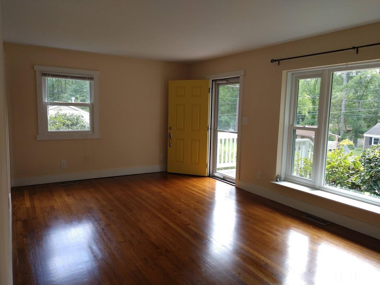 2521 Remington Road Raleigh, NC 27610 - Photo 4 of 30 an empty room with wooden floor and windows