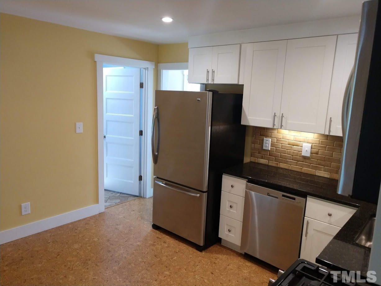 2521 Remington Road Raleigh, NC 27610 - Photo 7 of 30 a kitchen with metallic refrigerator and microwave