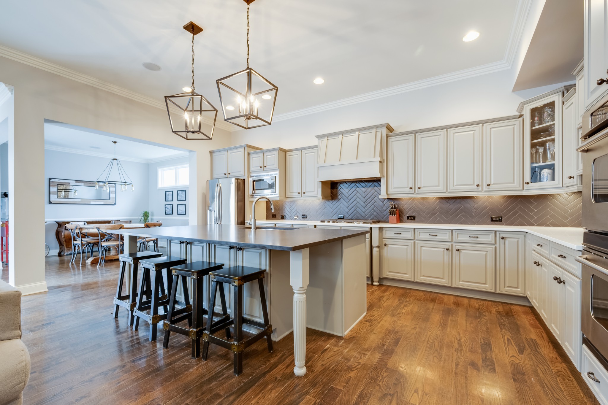 523 Ardmore Place Franklin, TN 37064 - Photo 11 of 24 a kitchen with stainless steel appliances granite countertop a island a stove a refrigerator a sink a dining table and chairs with wooden floor