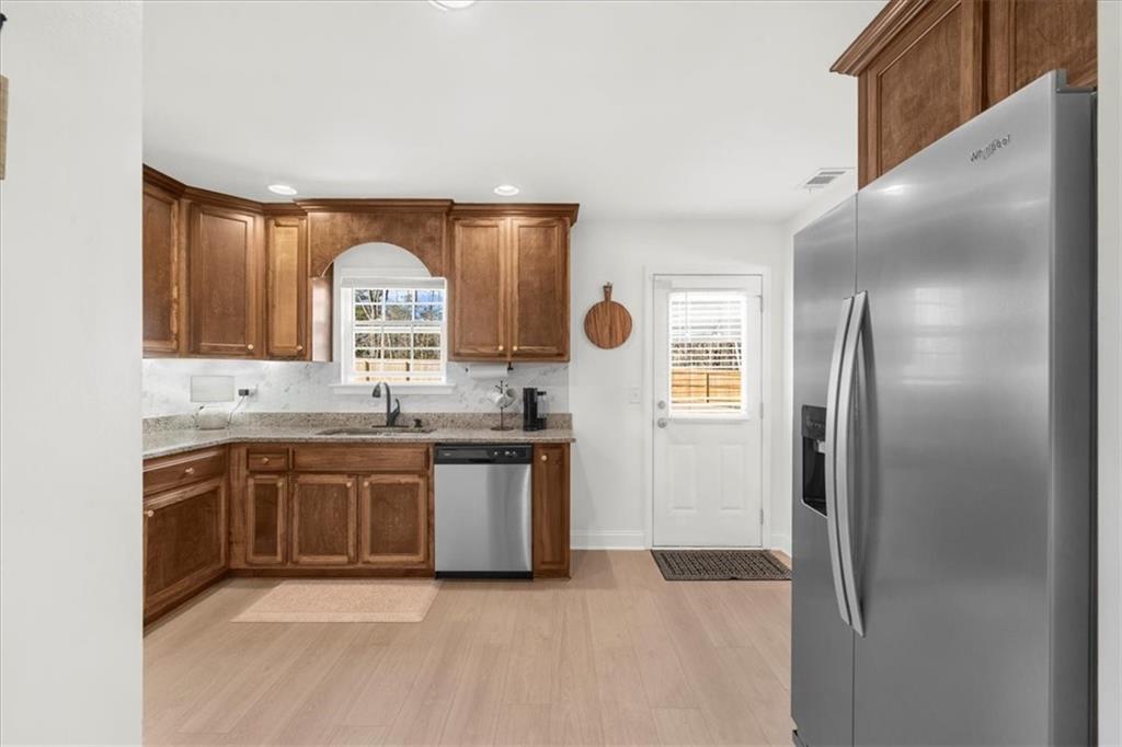 5413 Stepstone Way Gainesville, GA 30506 - Photo 12 of 36 a large kitchen with stainless steel appliances granite countertop a refrigerator and a sink