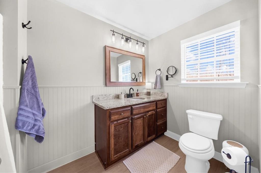 5413 Stepstone Way Gainesville, GA 30506 - Photo 21 of 36 a bathroom with a toilet a sink and a mirror