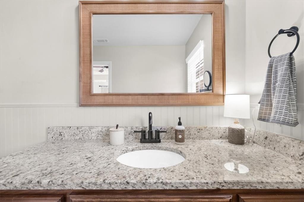 5413 Stepstone Way Gainesville, GA 30506 - Photo 24 of 36 a bathroom with a granite countertop sink and a mirror