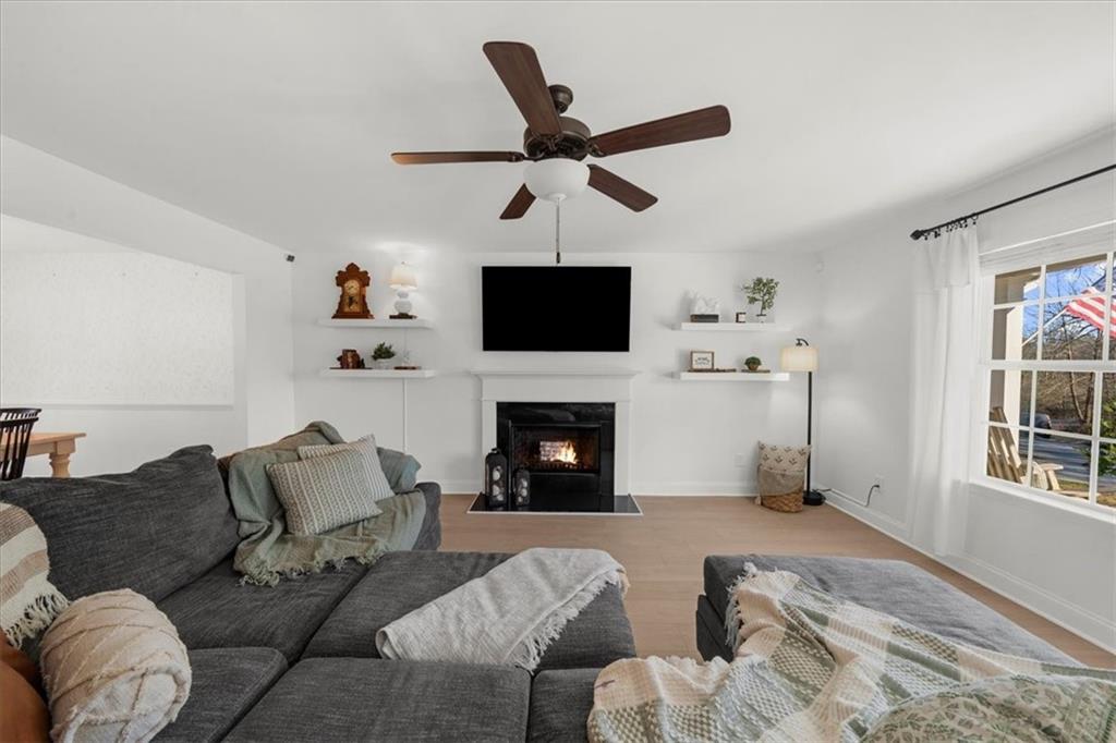5413 Stepstone Way Gainesville, GA 30506 - Photo 5 of 36 a living room with furniture a fireplace and a flat screen tv
