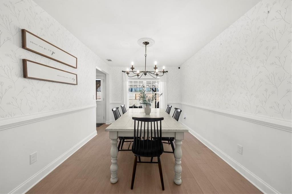 5413 Stepstone Way Gainesville, GA 30506 - Photo 8 of 36 a view of a dining room with furniture and wooden floor