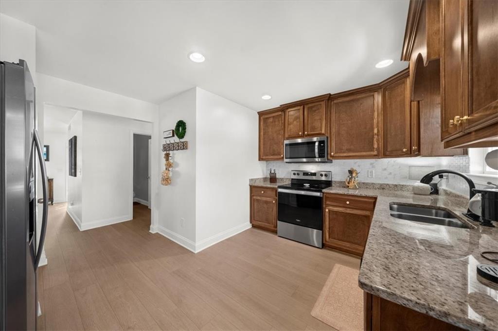 5413 Stepstone Way Gainesville, GA 30506 - Photo 10 of 36 a kitchen with granite countertop stainless steel appliances and refrigerator
