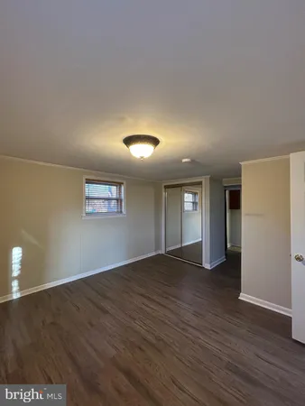 a view of a room with wooden floor