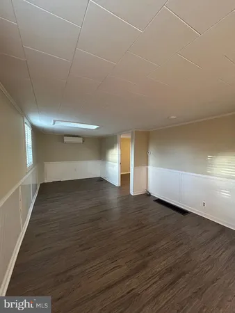 a view of a room with wooden floor