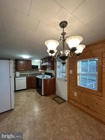 a kitchen with a sink a stove and refrigerator