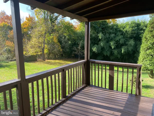 a view of a wooden deck next to a yard