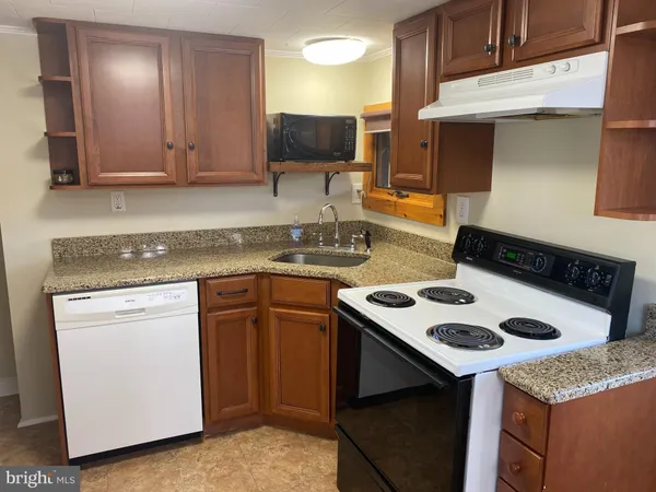 a white refrigerator freezer and a stove sitting inside of a kitchen