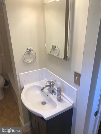 a bathroom with a toilet sink and mirror