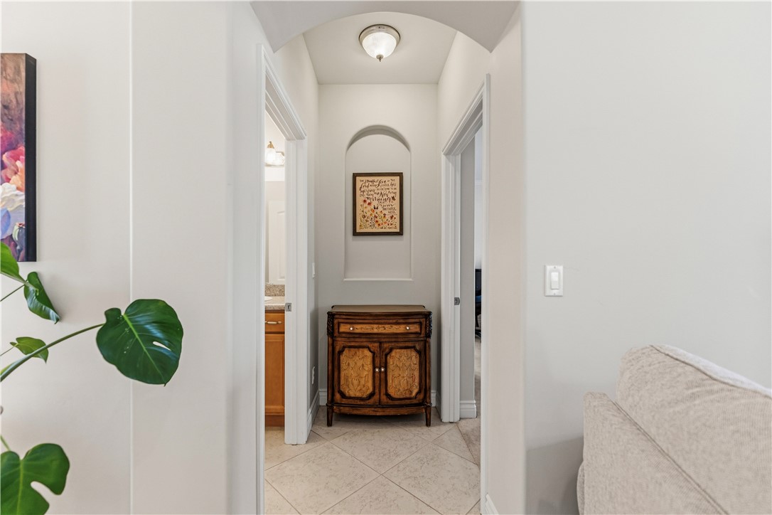 3315 Rainbow Mine Road Kingman, AZ 86401 - Photo 16 of 54 Hallway featuring an arched entryway, recessed wall niche, and tiled flooring
