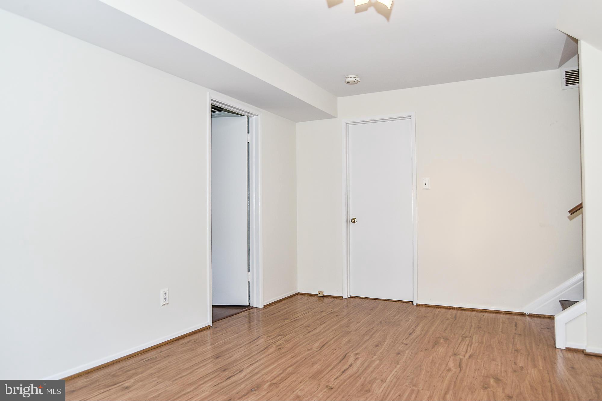 8140 Drayton Lane Springfield, VA 22151 - Photo 19 of 30 a view of an empty room with wooden floor