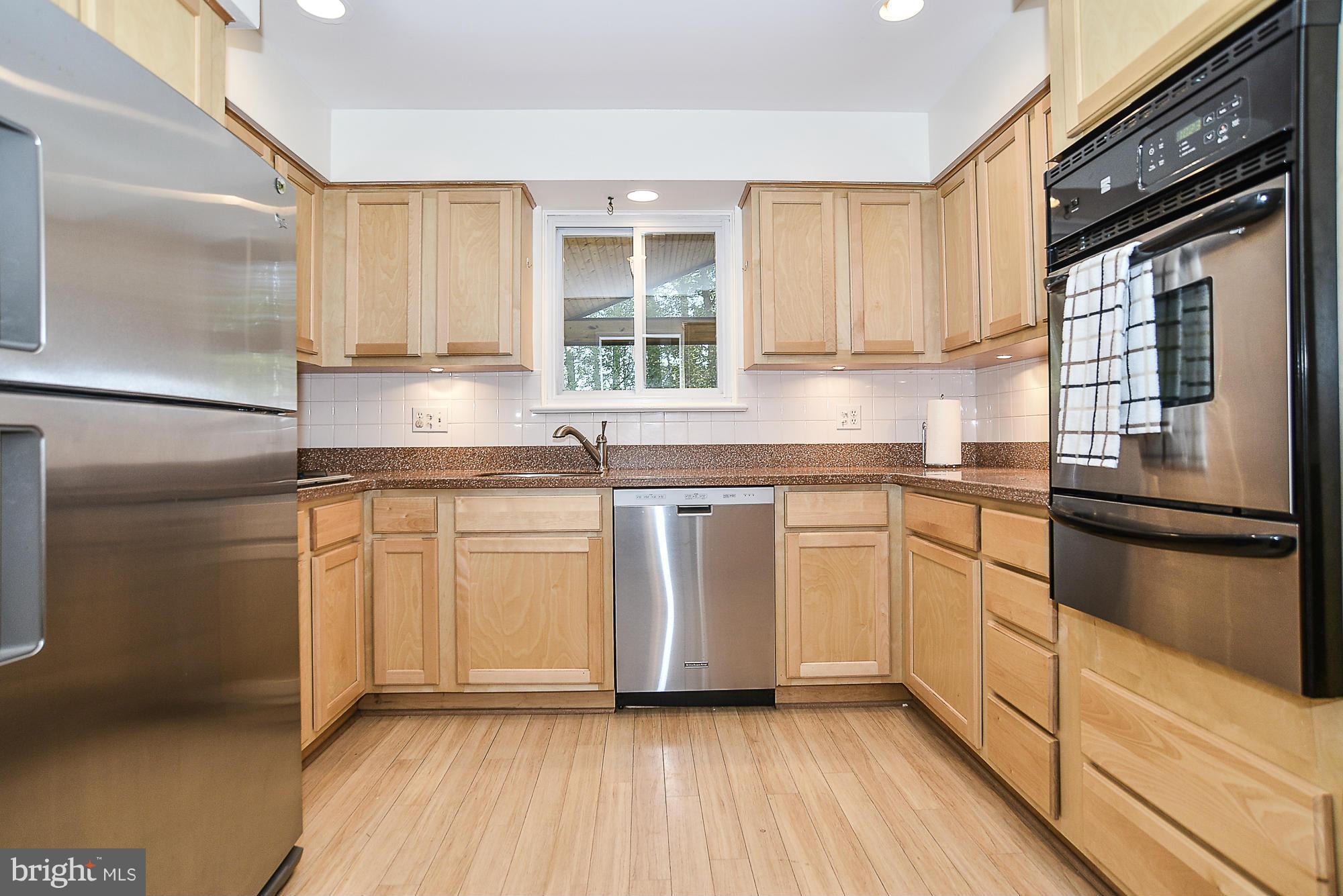 8140 Drayton Lane Springfield, VA 22151 - Photo 3 of 30 a kitchen with granite countertop stainless steel appliances a sink and cabinets