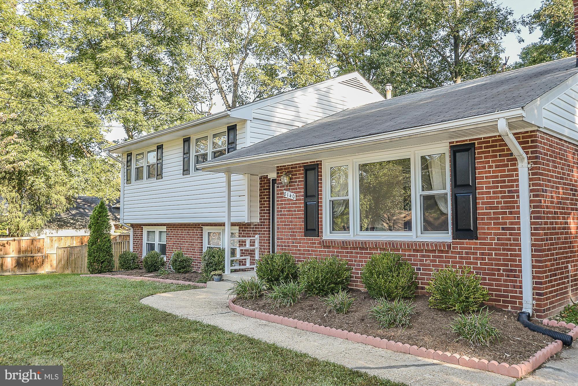 8140 Drayton Lane Springfield, VA 22151 - Photo 30 of 30 a front view of a house with a yard and outdoor seating