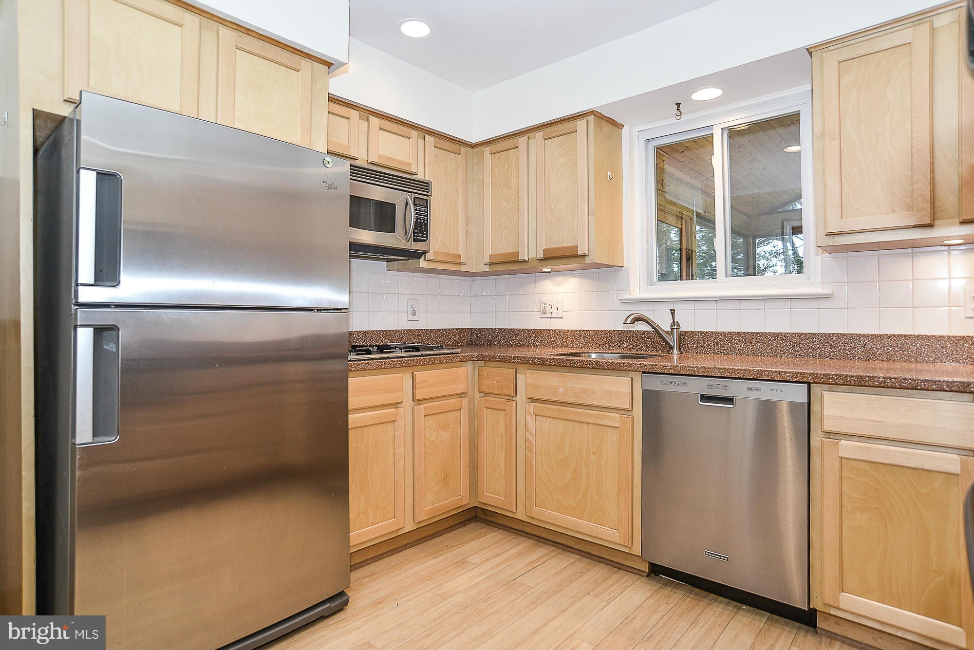 8140 Drayton Lane Springfield, VA 22151 - Photo 4 of 30 a kitchen with stainless steel appliances granite countertop a refrigerator and a sink