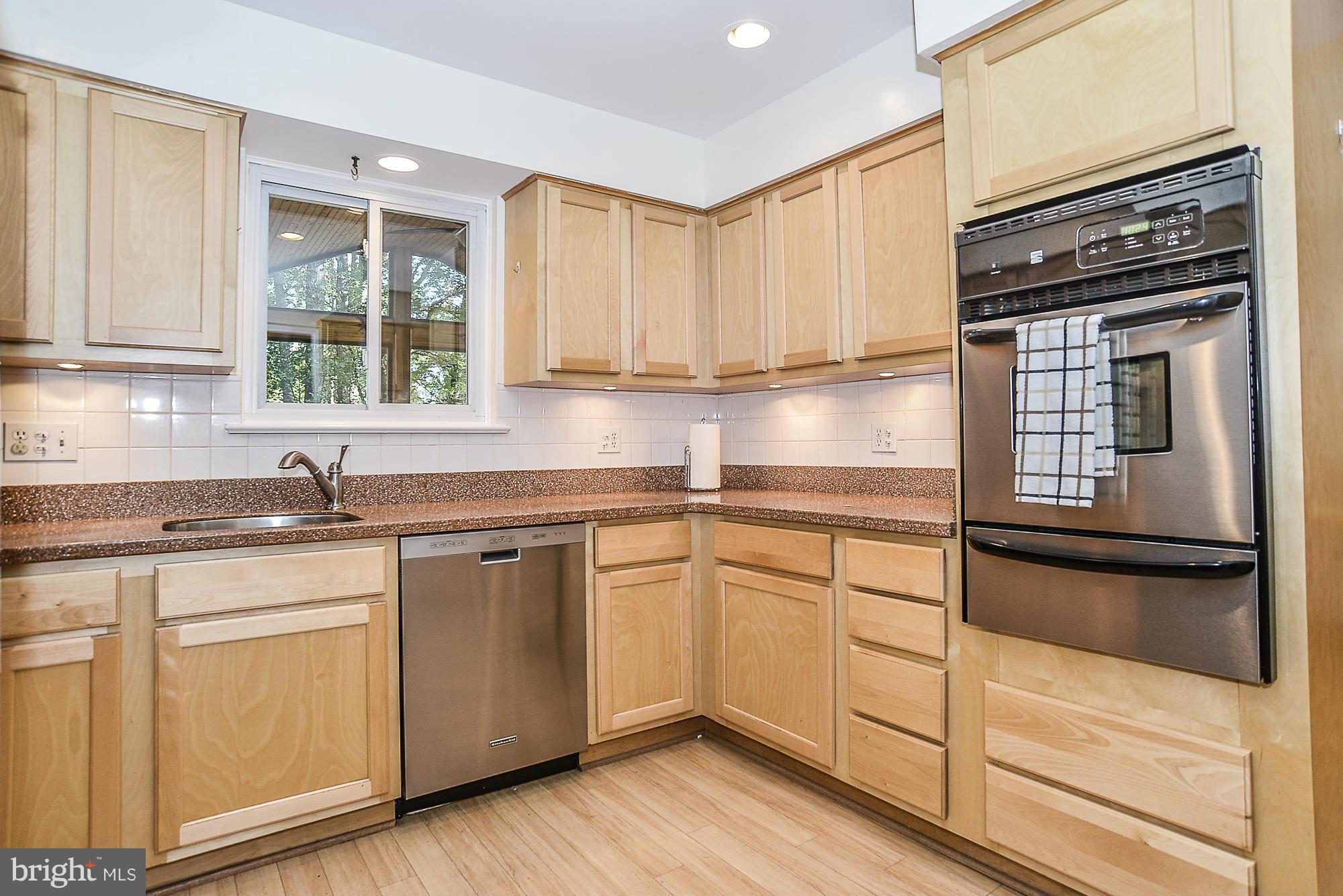 8140 Drayton Lane Springfield, VA 22151 - Photo 5 of 30 a kitchen with granite countertop cabinets stainless steel appliances and a sink