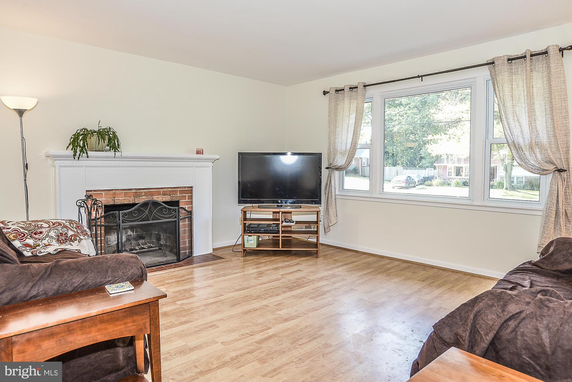 8140 Drayton Lane Springfield, VA 22151 - Photo 6 of 30 a living room with furniture and a fireplace