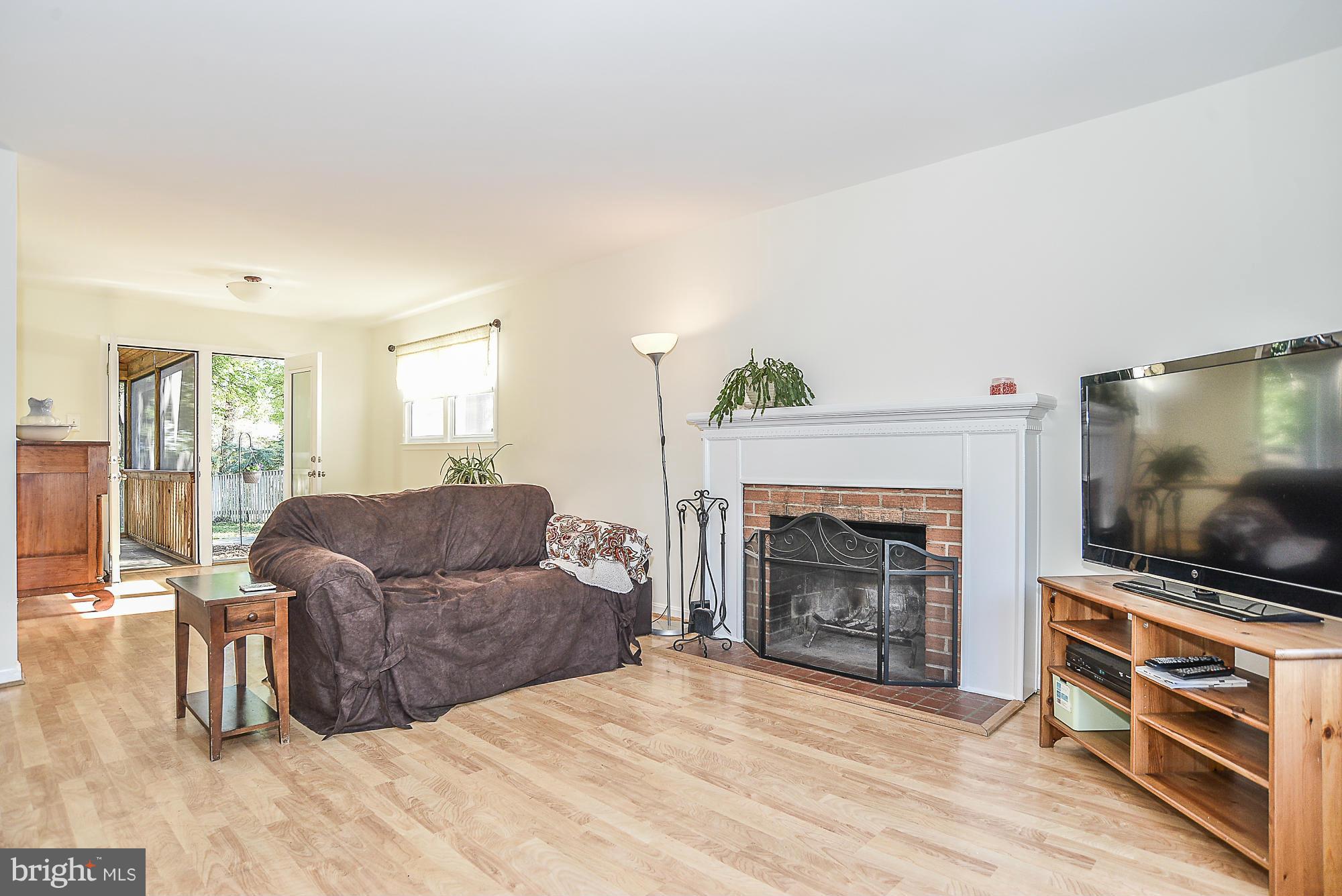 8140 Drayton Lane Springfield, VA 22151 - Photo 7 of 30 a living room with furniture a flat screen tv and a fireplace