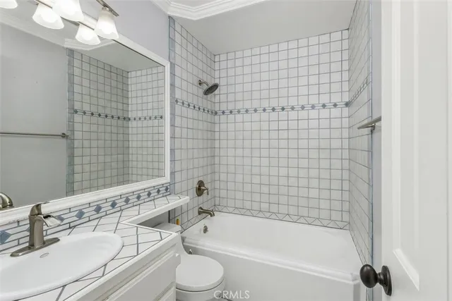 a bathroom with a bathtub shower sink vanity and a toilet