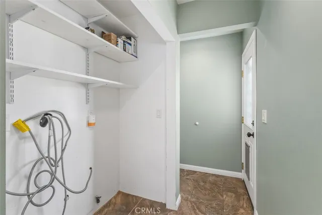 a view of a storage & utility room with rack on the wall